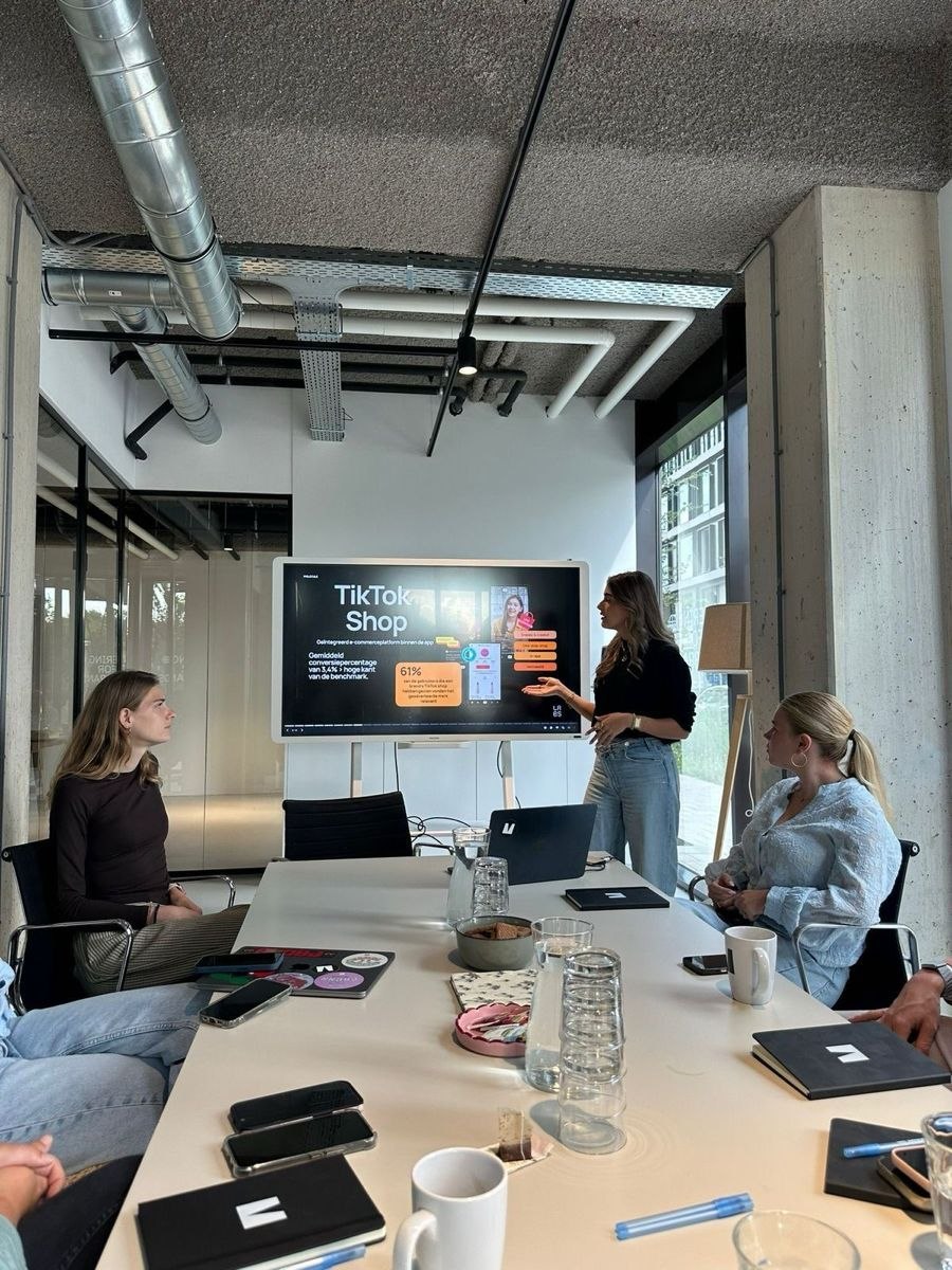 A team discussing a presentation around a meeting table